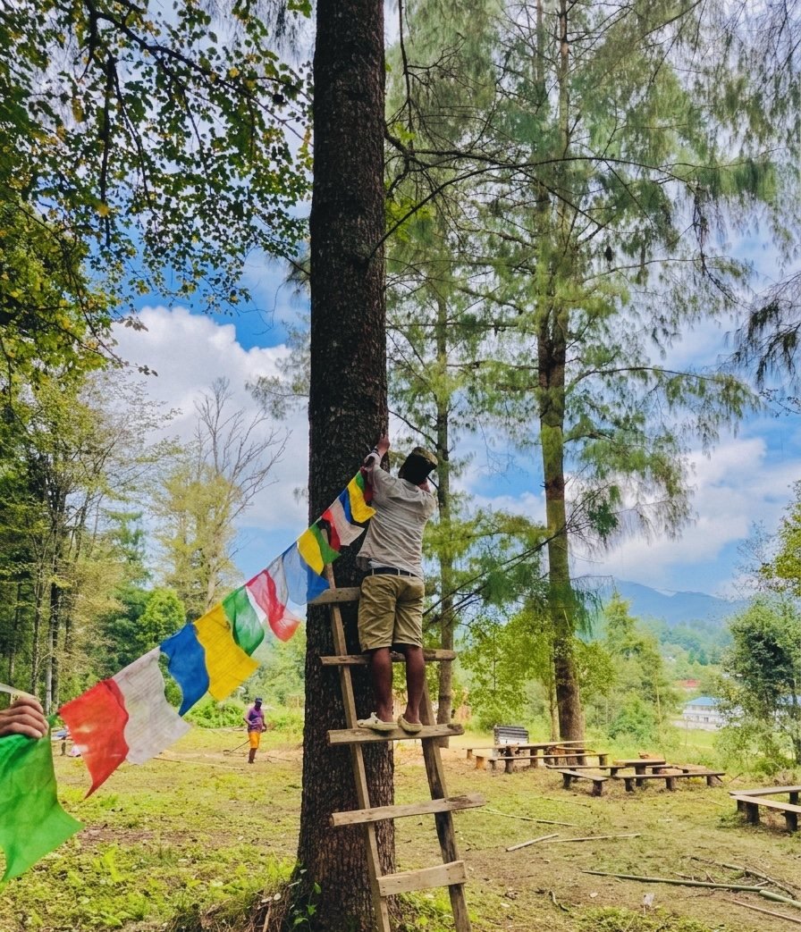 Basecamp team preparing colourful flags in the forest