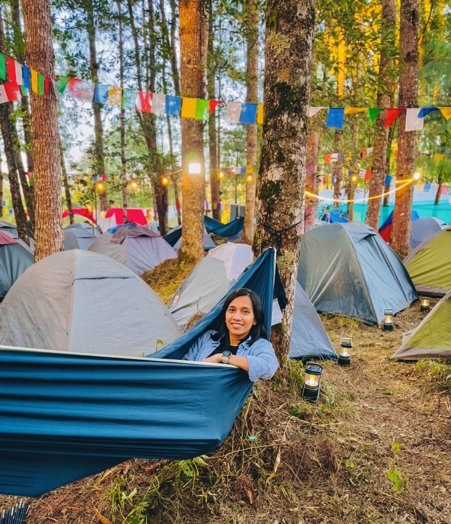 Guest relaxing in a hammock among Basecamp tents